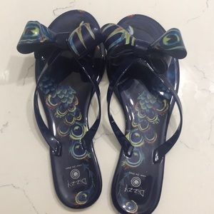 Sandals with peacock feathers and a bow